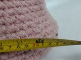 someone is measuring the length of a crochet bag with a measuring tape