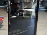 an image of a black refrigerator in a garage