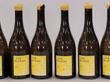 six bottles of wine are lined up in a row