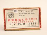 an old box of fly rod reel sitting on a white surface