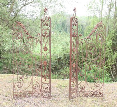 two iron gates that are standing next to each other