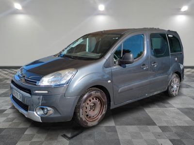 the small van is parked on a checkered floor in the garage