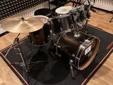 a drum set on a rug in a recording room