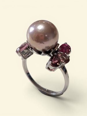 an image of a ring with a pearl and pink stones on it
