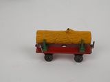 a toy train with a log on the back of it