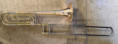 a trumpet and a trombone sitting on the floor