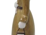 a ceramic figurine of a woman wearing a top hat and coat