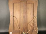 an image of a wooden cutting board with a rope attached to it