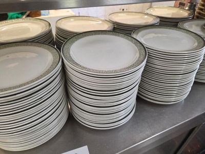 a lot of plates that are stacked on the counter