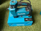 a small blue machine that is sitting on a green carpet