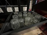many empty glasses in a glass case on the table