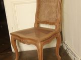 a wooden chair sitting in front of a white door