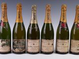 six bottles of champagne are lined up in a row