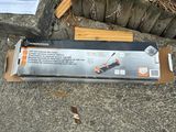 a box of tools sitting on the ground next to a plant