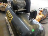a large air compressor sitting on a pallet in a warehouse