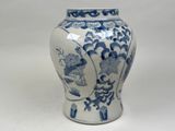 a blue and white vase sitting on a white surface