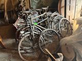 many bicycles that are parked in a garage