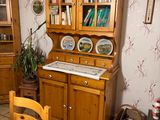 a wooden cabinet with a glass door in a room