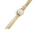 a close up of a watch on a white surface