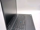 a laptop computer sitting on a table with a keyboard