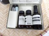 three bottles of skin care products in a box on a table