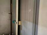 a door to a bathroom with a green light in it