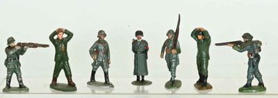 a lot of figurines of soldiers that are standing in a row