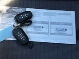 two car keys sitting on top of a piece of paper