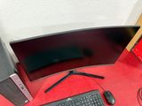 a computer desk with a monitor, keyboard, mouse, and mouse pad