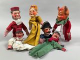 five dolls that are sitting next to each other on a table