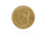 a close up of a gold coin on a white surface