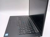 a laptop with a black keyboard on a white surface