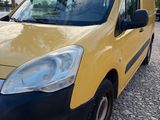 the yellow van is parked on the side of the road