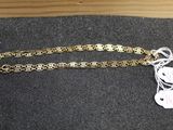 a close up of a gold chain with a price tag on it