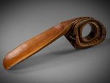 a close up of a wooden spoon with a handle on a gray surface