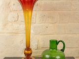 two vases sitting on a table next to each other