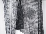 a black and white photo of a dress hanging on a clothes rack