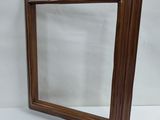 an image of a mirror with a wooden frame on a white background