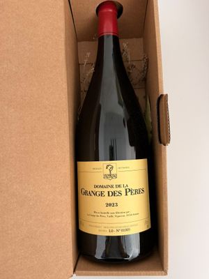 a bottle of wine in a cardboard box on a table