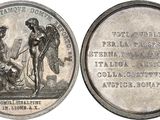 an old silver coin with a picture of a woman and a man on it