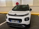 a small white car parked in a parking space