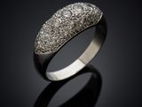 a close up of a diamond ring on a black surface