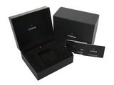 the box is black and has a red watch inside of it