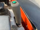 a close up view of a motor bike with a green button