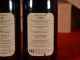two bottles of wine that are on a table