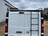 a white van with a ladder on the back of it