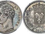a silver coin with the image of a man ' s head on it