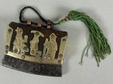 a picture of a gold and black purse with a green tassel