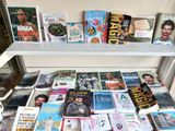many books that are on a shelf in a room