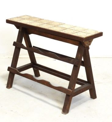 a wooden bench with a tile top on a white floor
